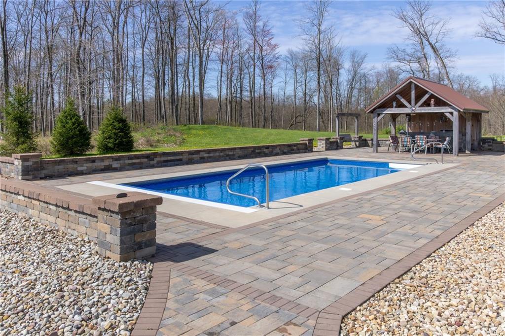 130 Parker Road Mercer, PA 16137 - Photo 43 of 50 a view of swimming pool with lawn chairs and wooden fence