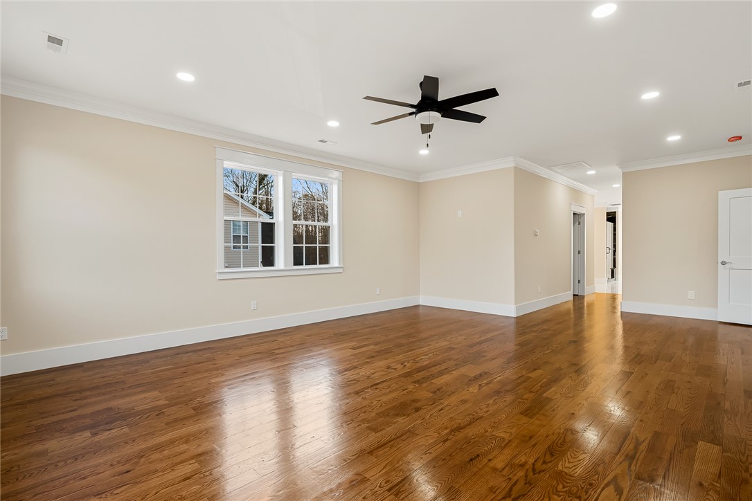 303 Regency Circle Anderson, SC 29625 - Photo 15 of 50 This expansive room features elegant hardwood flooring and abundant natural light, creating an inviting atmosphere.