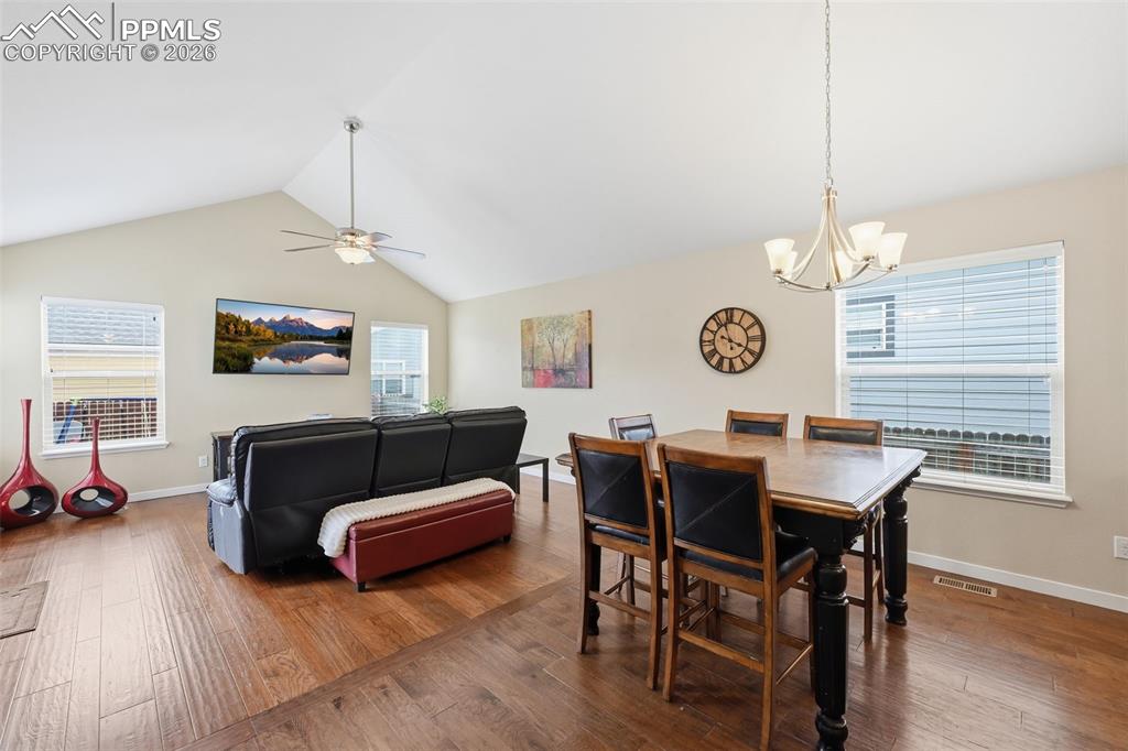 6565 Watusi Road Peyton, CO 80831 - Photo 13 of 36 a living room with furniture a window and a chandelier