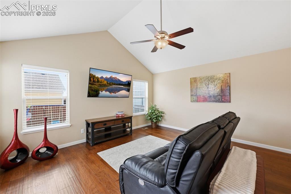 6565 Watusi Road Peyton, CO 80831 - Photo 14 of 36 a living room with furniture a flat screen tv and a window
