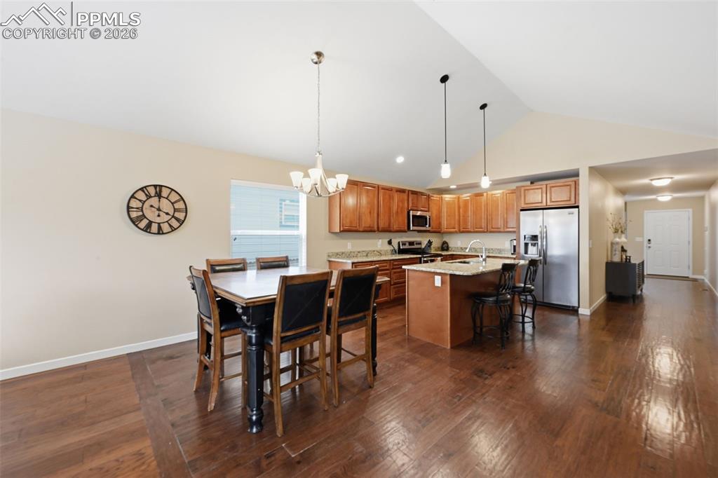 6565 Watusi Road Peyton, CO 80831 - Photo 18 of 36 a open kitchen with a table and chairs