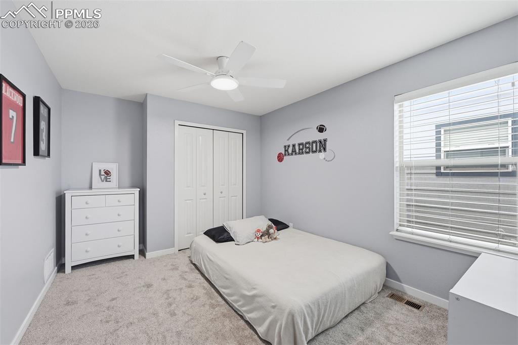 6565 Watusi Road Peyton, CO 80831 - Photo 24 of 36 a bedroom with a bed and a window