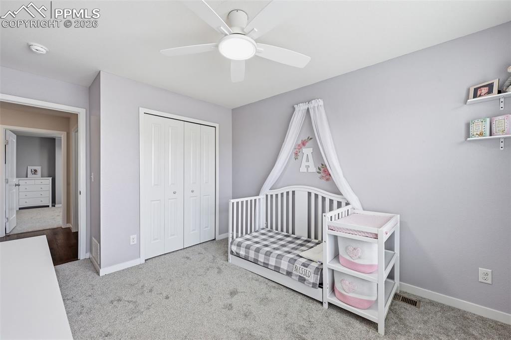 6565 Watusi Road Peyton, CO 80831 - Photo 26 of 36 a view of a room with stairs and a ceiling fan