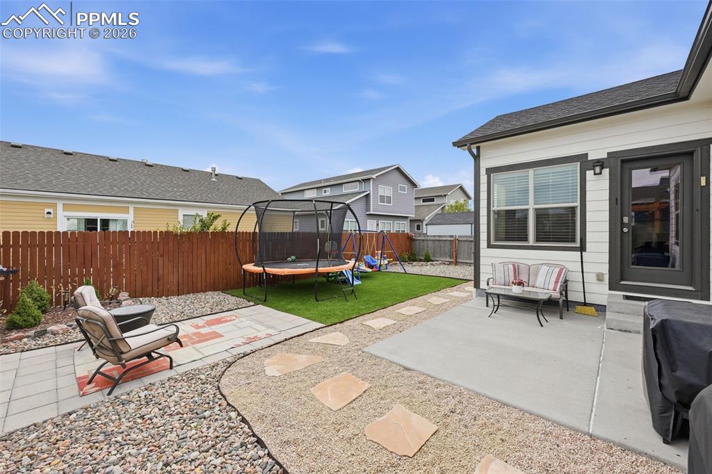 6565 Watusi Road Peyton, CO 80831 - Photo 28 of 36 a view of a house with backyard sitting area and garden