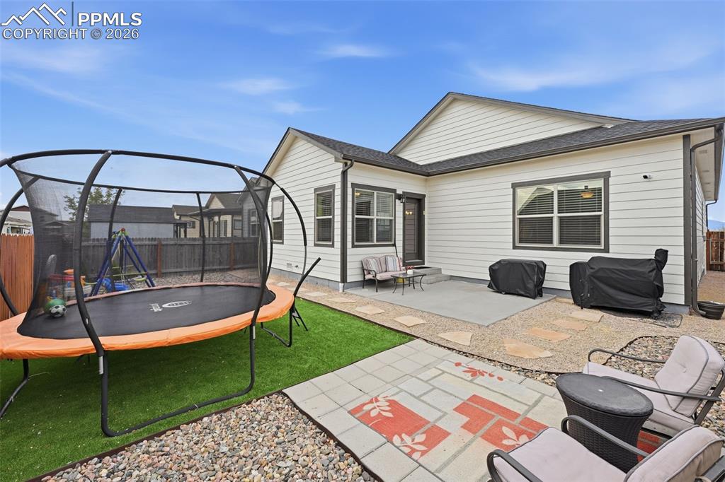6565 Watusi Road Peyton, CO 80831 - Photo 29 of 36 a patio with a table and chairs