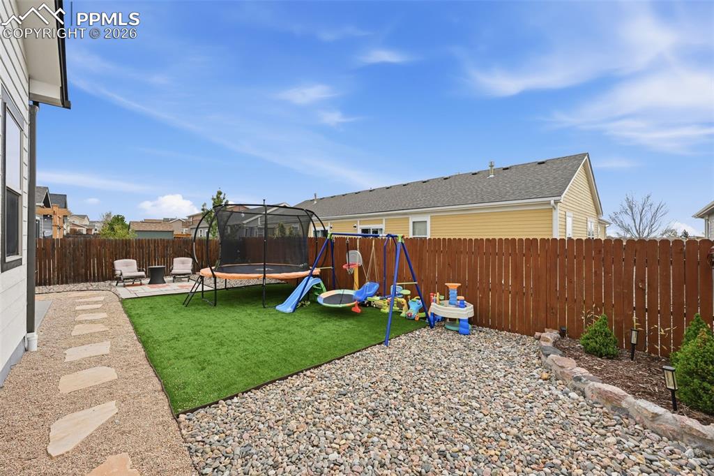 6565 Watusi Road Peyton, CO 80831 - Photo 30 of 36 a view of a backyard with sitting area