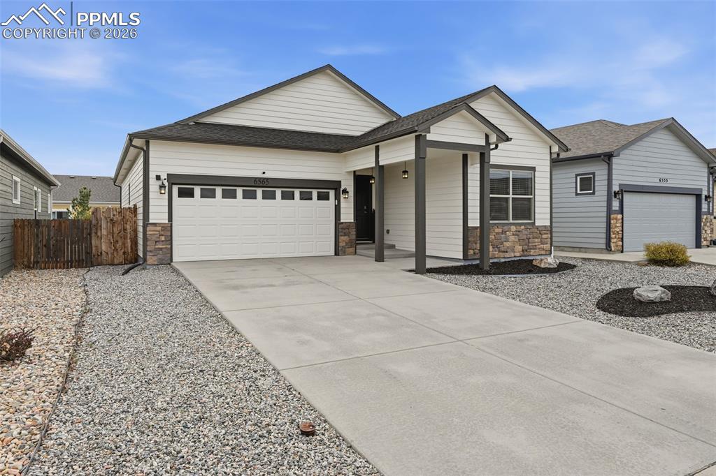6565 Watusi Road Peyton, CO 80831 - Photo 4 of 36 a front view of a house with a yard