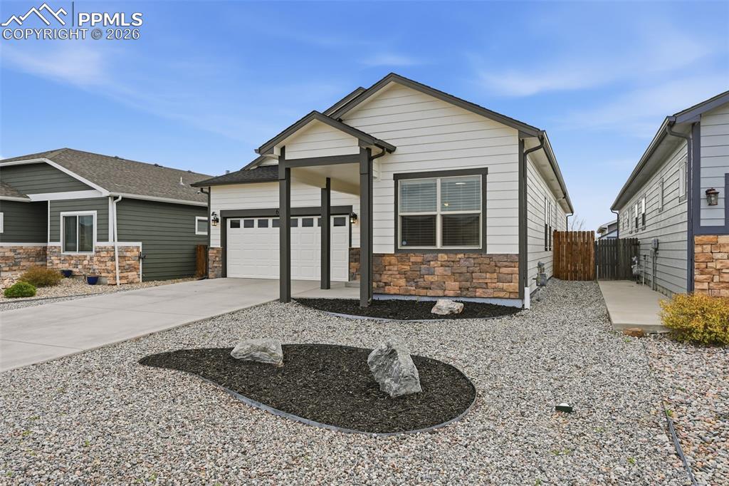 6565 Watusi Road Peyton, CO 80831 - Photo 6 of 36 a front view of a house with garden
