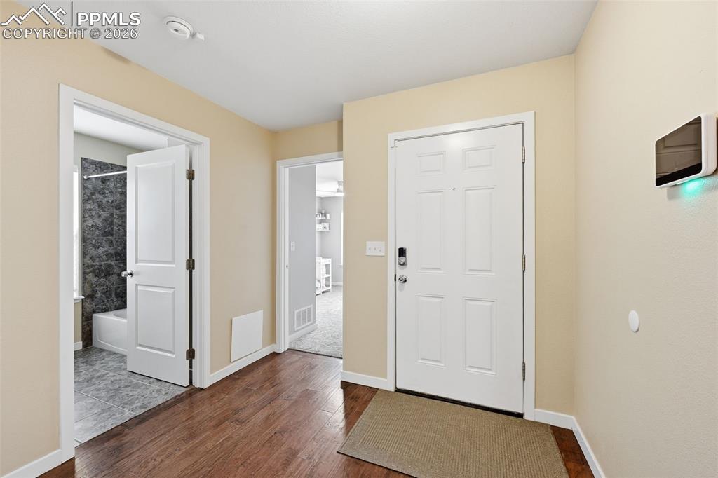 6565 Watusi Road Peyton, CO 80831 - Photo 7 of 36 a view of a hallway with wooden floor and closet