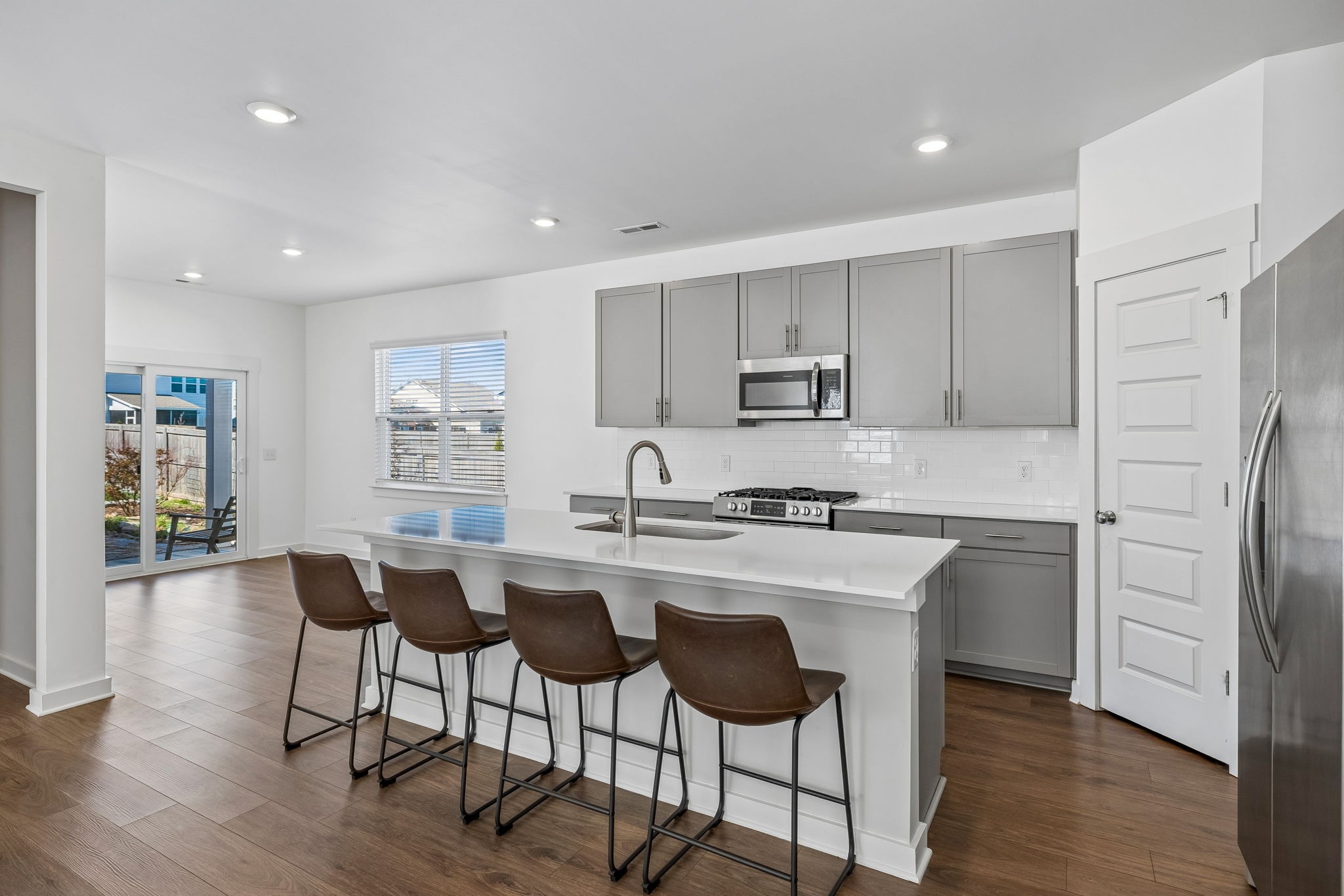 167 Harvest Point Boulevard Spring Hill, TN 37174 - Photo 18 of 55 a kitchen with stainless steel appliances white cabinets and wooden floor