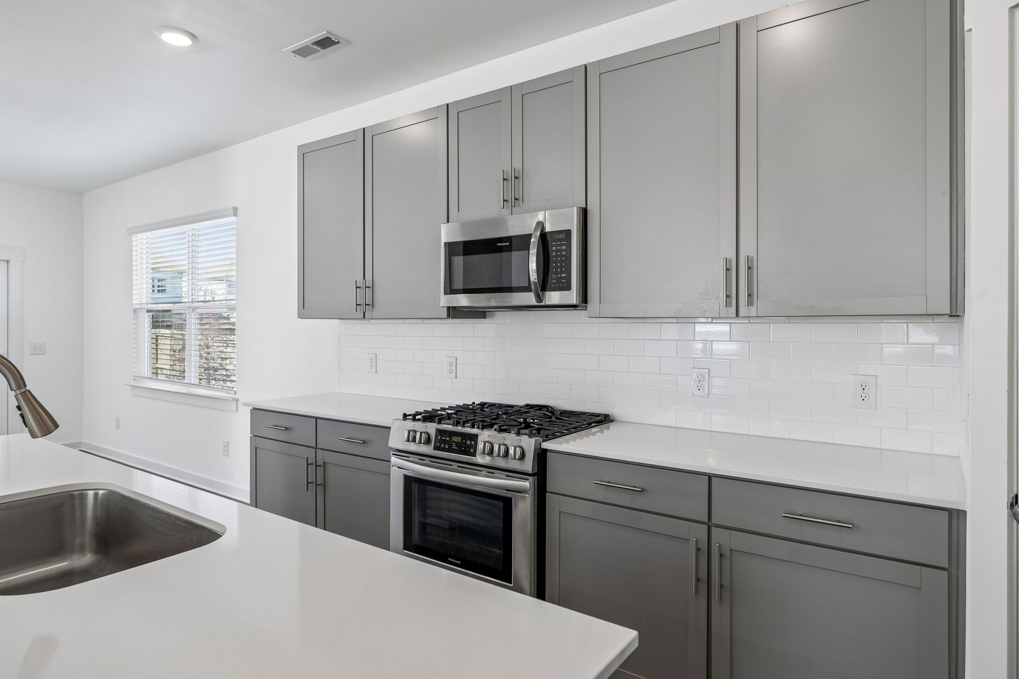 167 Harvest Point Boulevard Spring Hill, TN 37174 - Photo 19 of 55 a kitchen with granite countertop white cabinets and black stainless steel appliances