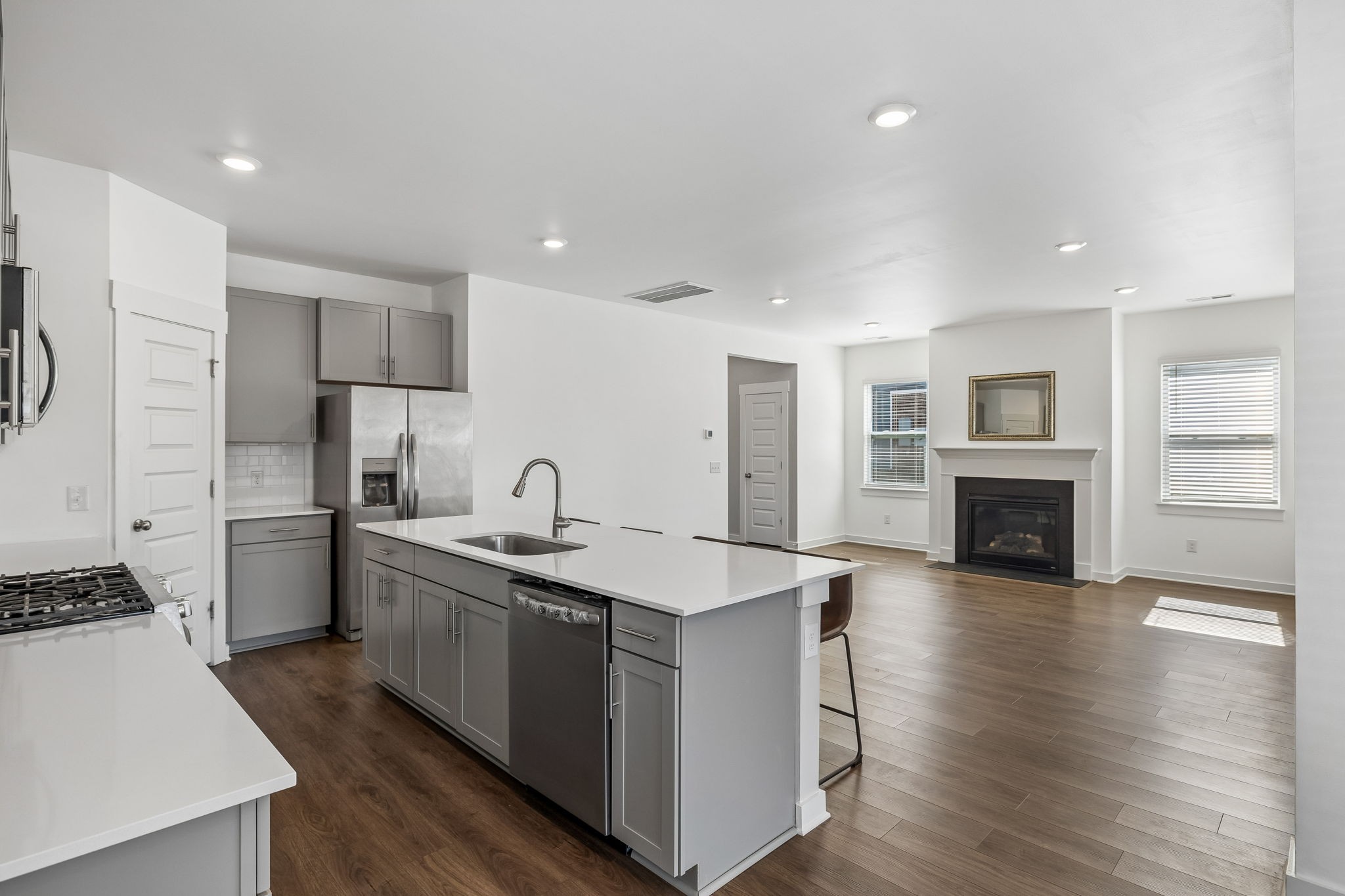 167 Harvest Point Boulevard Spring Hill, TN 37174 - Photo 22 of 55 a kitchen with a sink a refrigerator and a stove
