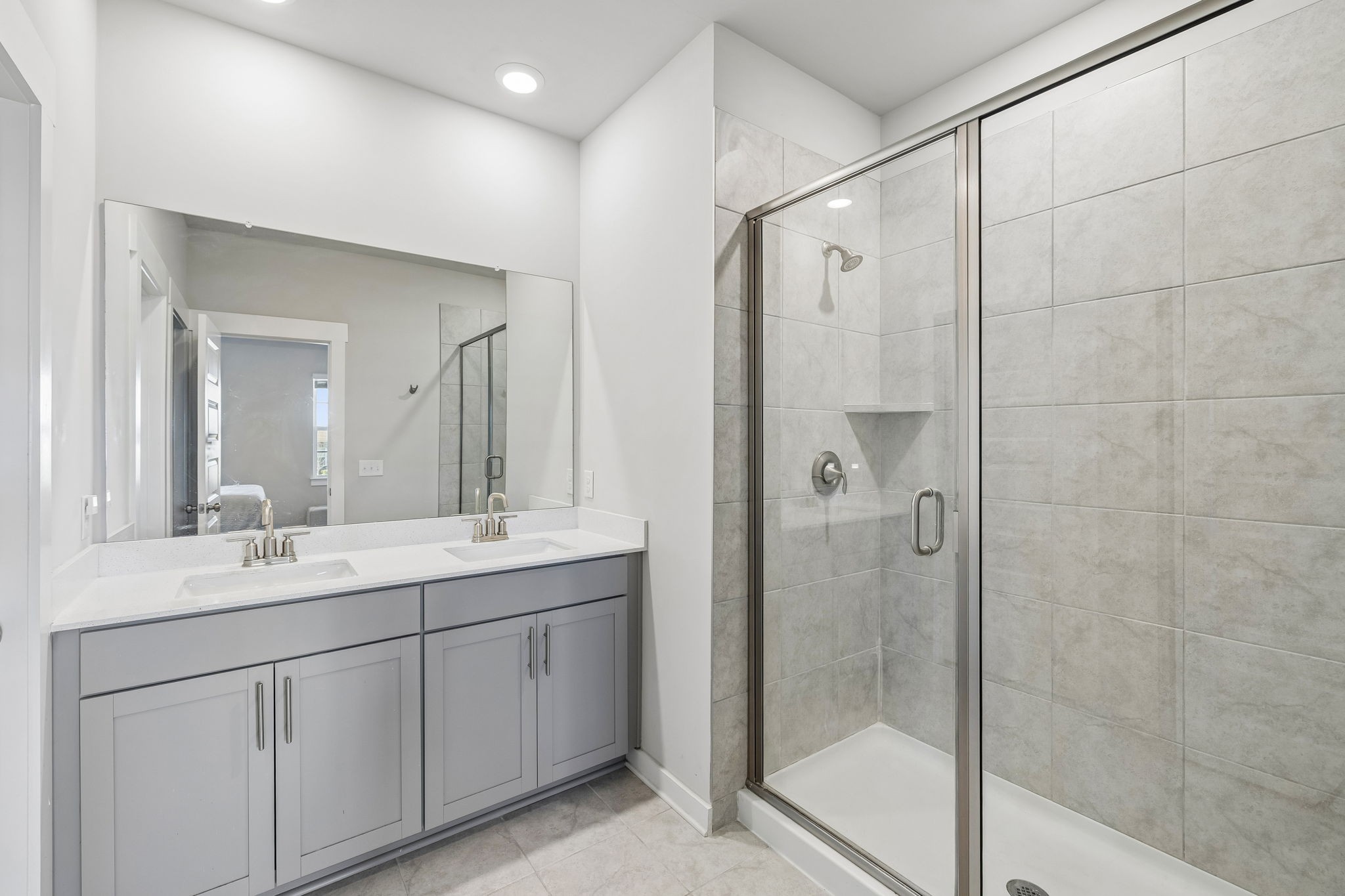 167 Harvest Point Boulevard Spring Hill, TN 37174 - Photo 31 of 55 a bathroom with a double vanity sink mirror and shower