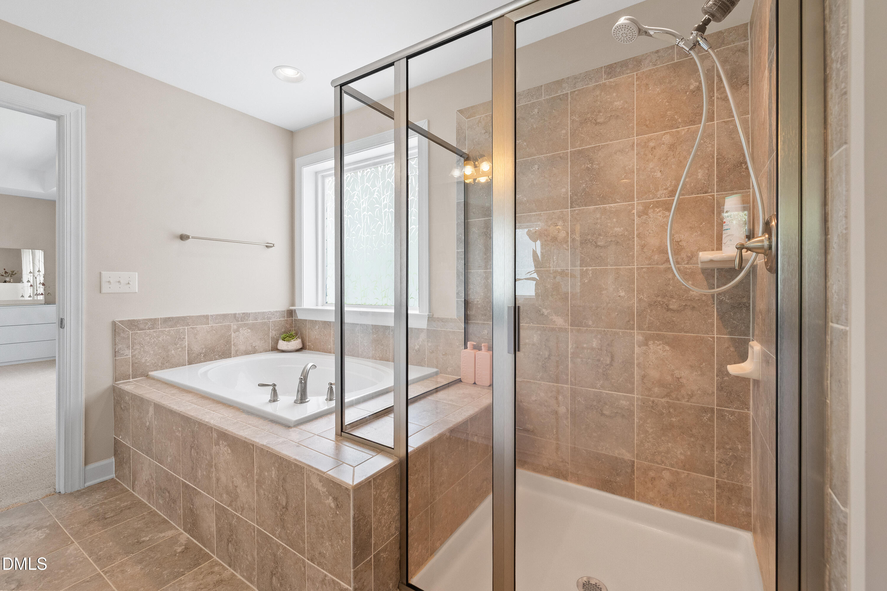 8059 Gilano Drive Raleigh, NC 27603 - Photo 29 of 43 a bathroom with a tub and a sink