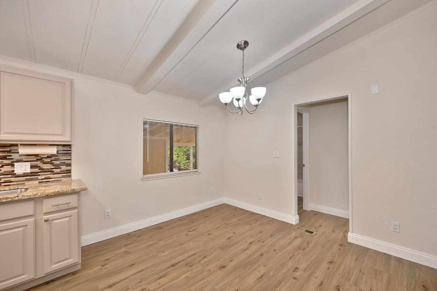 4420 Pleasant Valley Road, Unit 105 Diamond Springs, CA 95619 - Photo 12 of 33 a view of a kitchen with wooden floor and stainless steel appliances