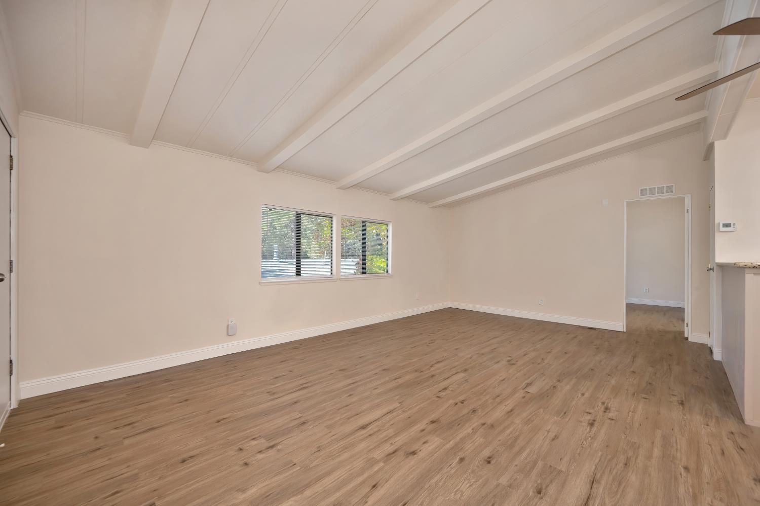4420 Pleasant Valley Road, Unit 105 Diamond Springs, CA 95619 - Photo 13 of 33 a view of an empty room with wooden floor and a window