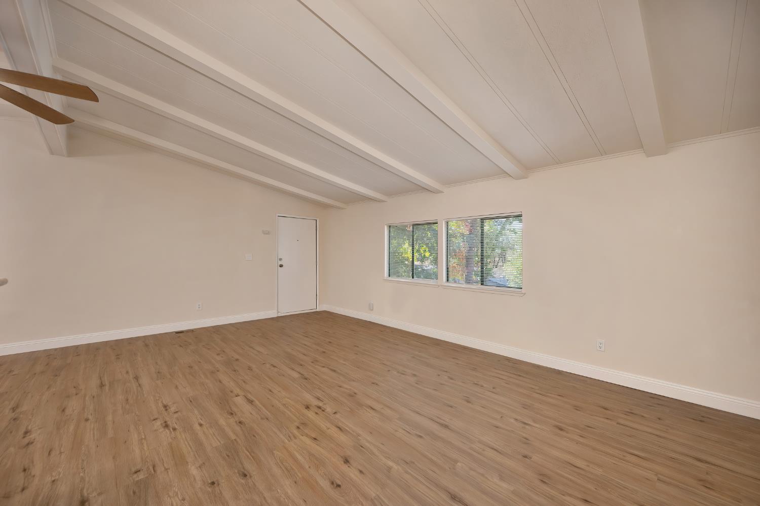 4420 Pleasant Valley Road, Unit 105 Diamond Springs, CA 95619 - Photo 15 of 33 a view of an empty room with wooden floor and a window