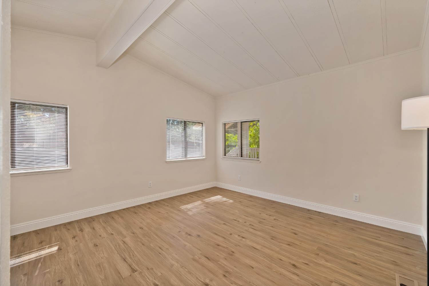 4420 Pleasant Valley Road, Unit 105 Diamond Springs, CA 95619 - Photo 19 of 33 a view of an empty room with wooden floor and a window