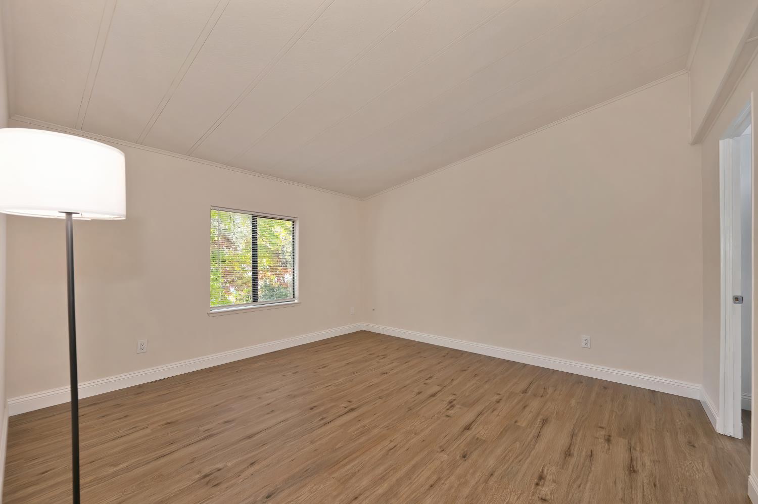 4420 Pleasant Valley Road, Unit 105 Diamond Springs, CA 95619 - Photo 21 of 33 a view of an empty room with wooden floor and a window