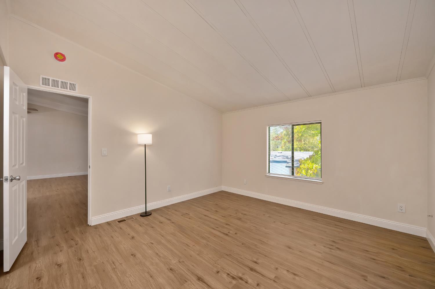 4420 Pleasant Valley Road, Unit 105 Diamond Springs, CA 95619 - Photo 23 of 33 a view of an empty room with a window and wooden floor