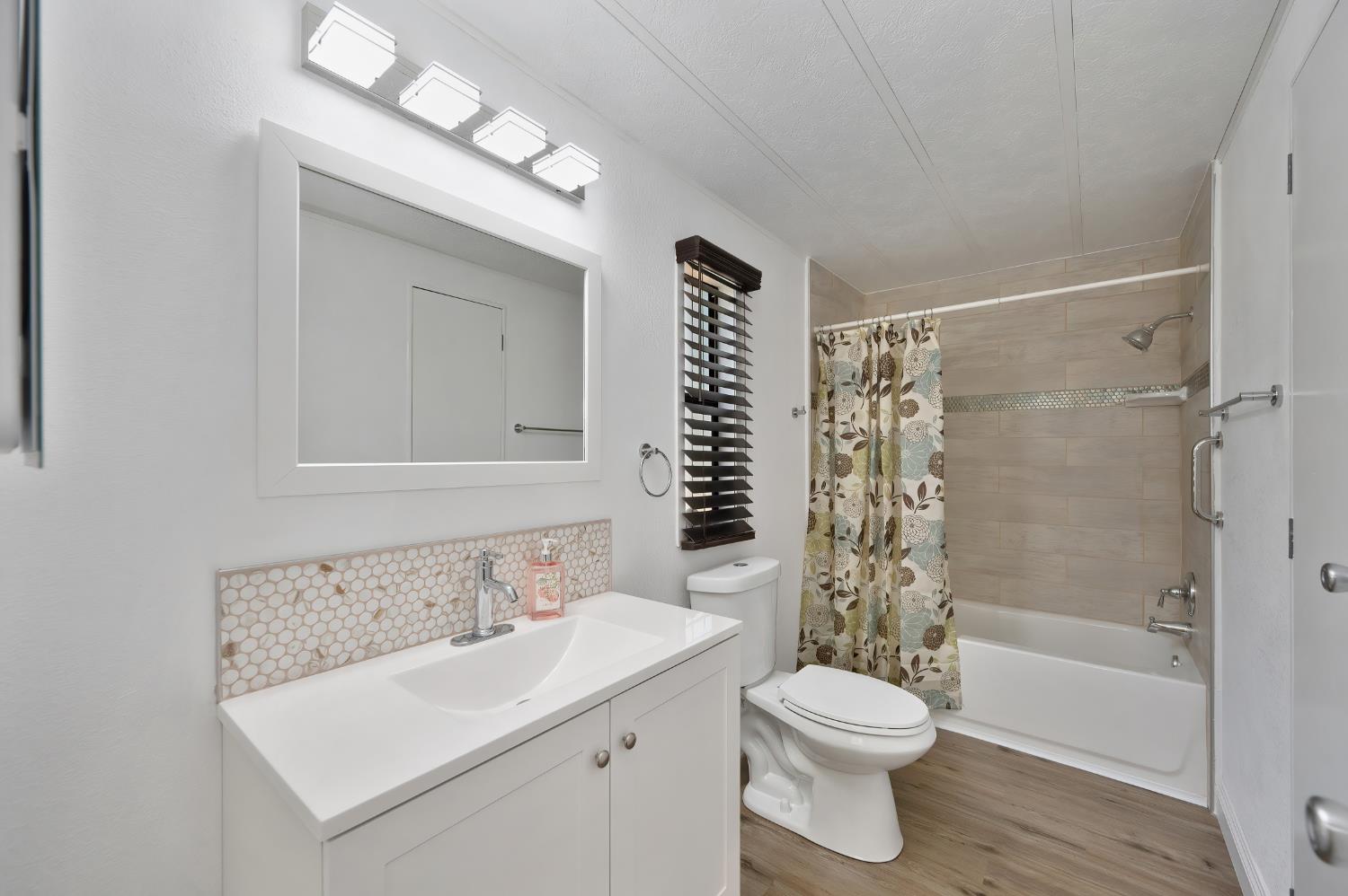 4420 Pleasant Valley Road, Unit 105 Diamond Springs, CA 95619 - Photo 24 of 33 a bathroom with a sink toilet and shower