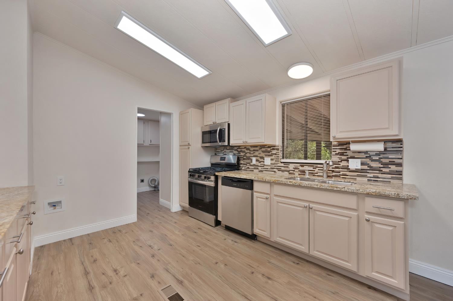 4420 Pleasant Valley Road, Unit 105 Diamond Springs, CA 95619 - Photo 6 of 33 a kitchen with stainless steel appliances granite countertop a stove and cabinets