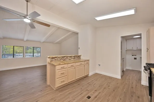 a kitchen with a stove oven and white cabinets