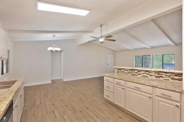 a kitchen with a sink cabinets and wooden floor