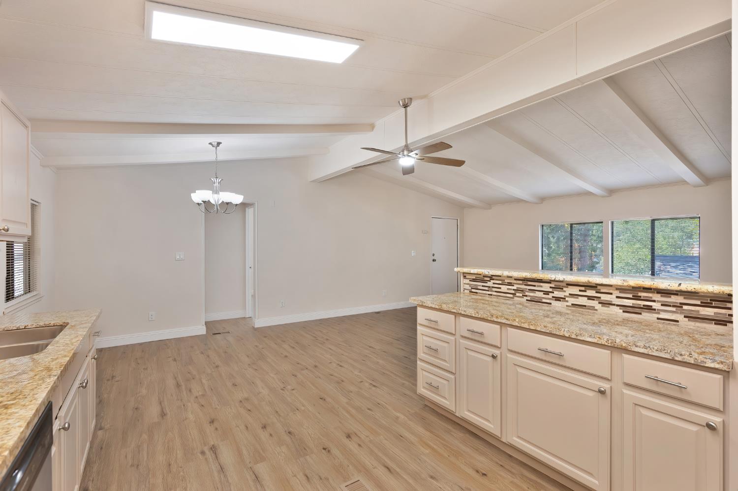 4420 Pleasant Valley Road, Unit 105 Diamond Springs, CA 95619 - Photo 9 of 33 a kitchen with a sink cabinets and wooden floor