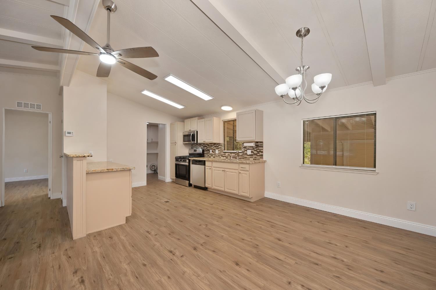 4420 Pleasant Valley Road, Unit 105 Diamond Springs, CA 95619 - Photo 10 of 33 a view of a kitchen with a sink stainless steel appliances and cabinets