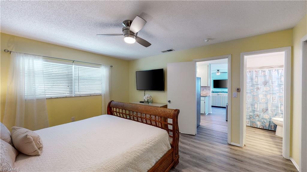 509 Shore Road Nokomis, FL 34275 - Photo 12 of 50 a bedroom with a bed and wooden floor