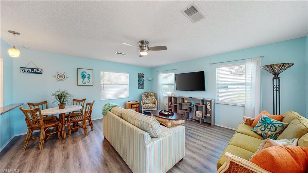 509 Shore Road Nokomis, FL 34275 - Photo 13 of 50 a living room with furniture and a flat screen tv
