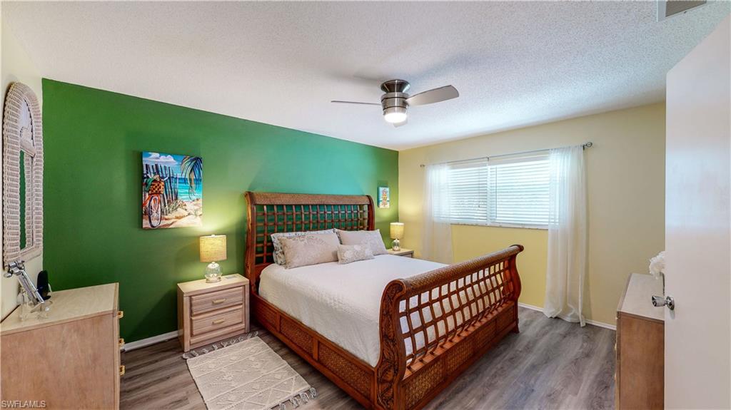 509 Shore Road Nokomis, FL 34275 - Photo 14 of 50 a bedroom with a bed and a dresser