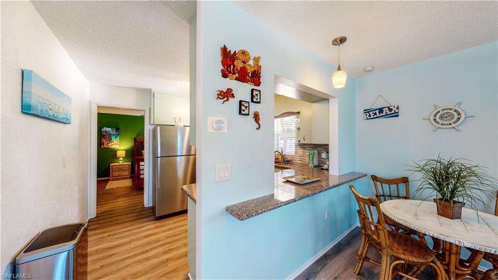 509 Shore Road Nokomis, FL 34275 - Photo 15 of 50 a dining room with furniture and wooden floor