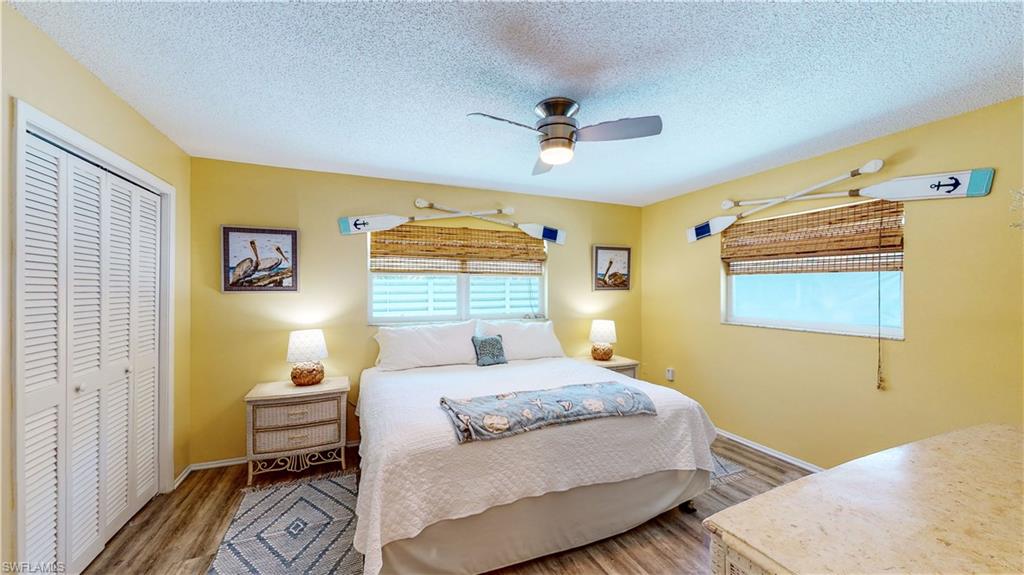 509 Shore Road Nokomis, FL 34275 - Photo 21 of 50 a bedroom with a bed and wooden floor