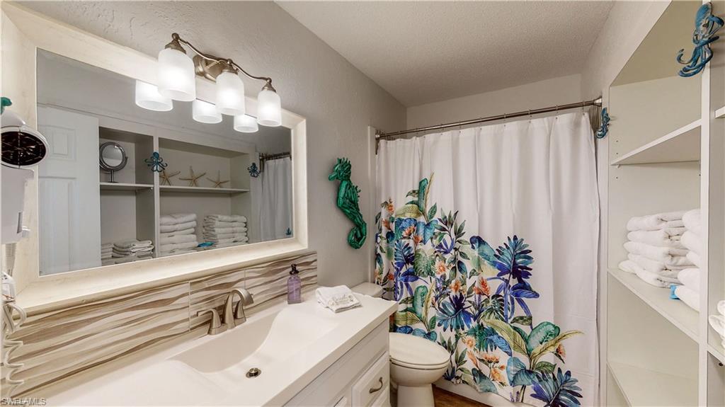509 Shore Road Nokomis, FL 34275 - Photo 22 of 50 a bathroom with a sink a mirror and a toilet