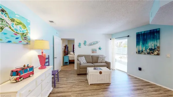 a living room with furniture and a mirror