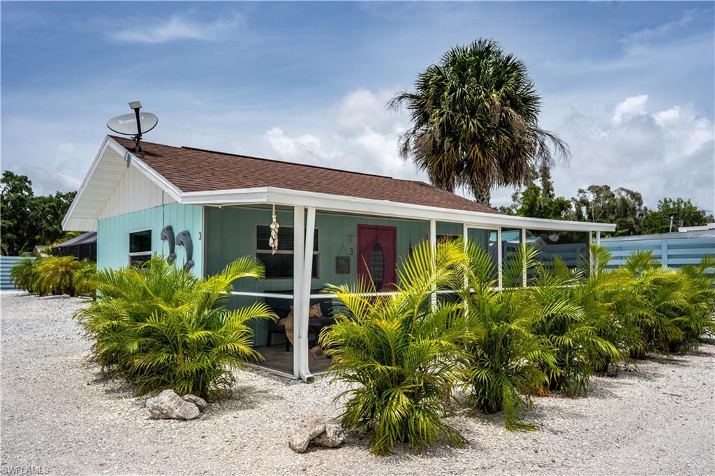 509 Shore Road Nokomis, FL 34275 - Photo 28 of 50 front view of a house with a garden
