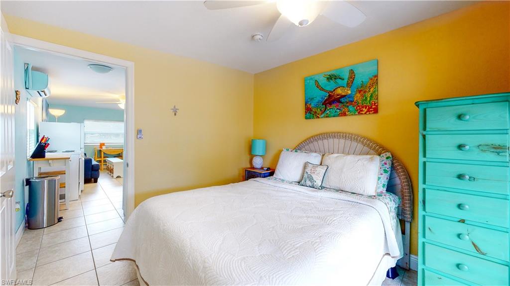 509 Shore Road Nokomis, FL 34275 - Photo 46 of 50 a bedroom with a bed and a dresser