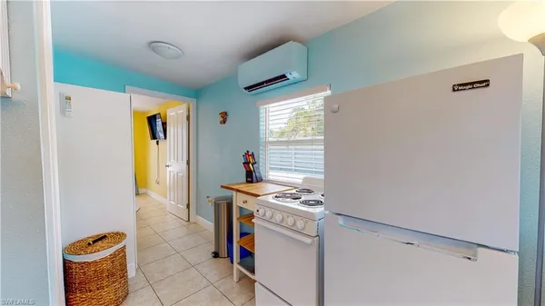 a kitchen with stainless steel appliances kitchen island granite countertop a sink dishwasher stove and microwave
