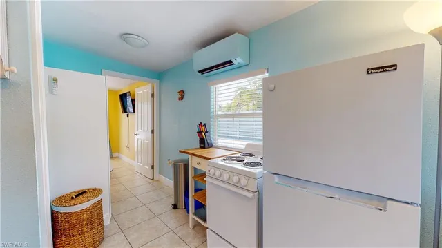 a kitchen with stainless steel appliances kitchen island granite countertop a sink dishwasher stove and microwave