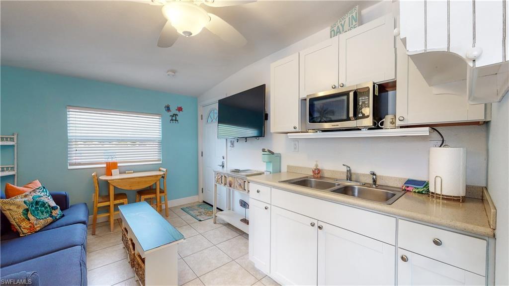 509 Shore Road Nokomis, FL 34275 - Photo 48 of 50 a kitchen with stainless steel appliances kitchen island granite countertop a sink dishwasher stove and microwave