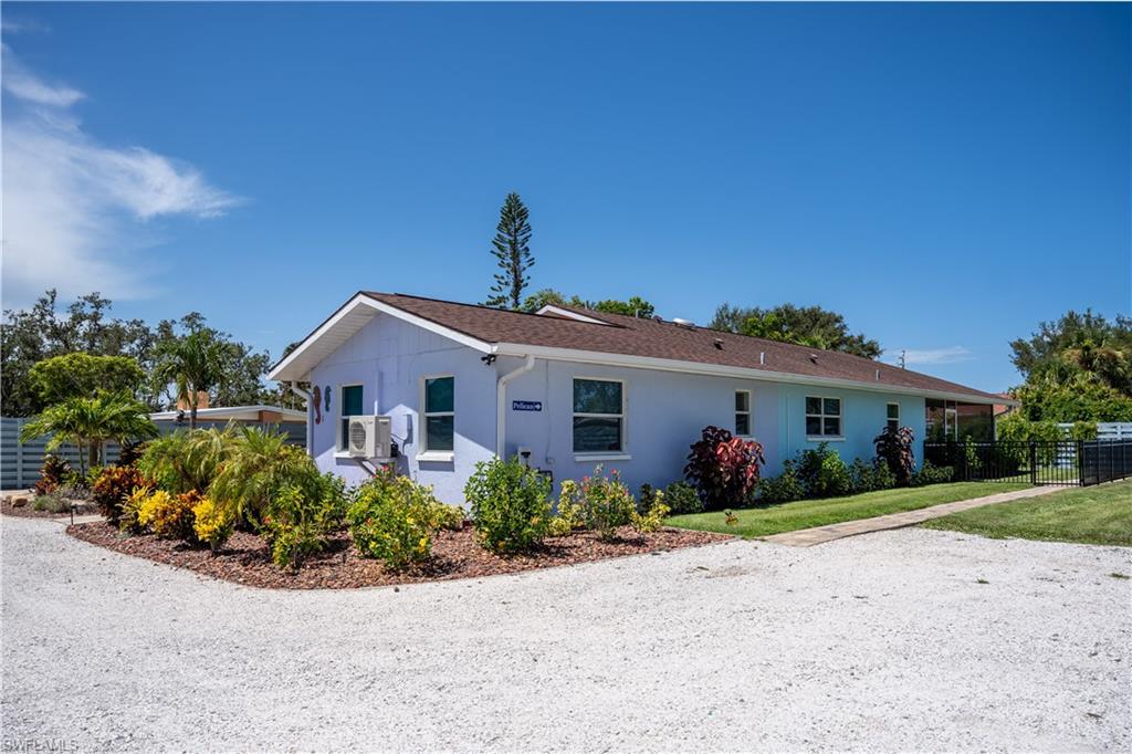 509 Shore Road Nokomis, FL 34275 - Photo 8 of 50 a front view of a house with garden