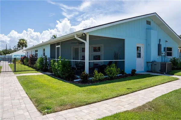 a view of a house with backyard porch and sitting area
