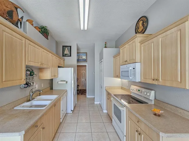 a kitchen with stainless steel appliances granite countertop a sink and a stove