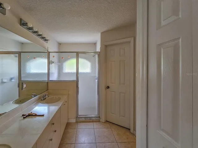 a room with a mirror and a shower