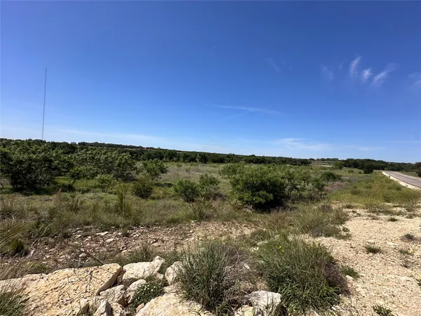 a view of a large building with a forest