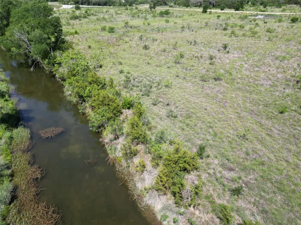 a view of a lake with a yard