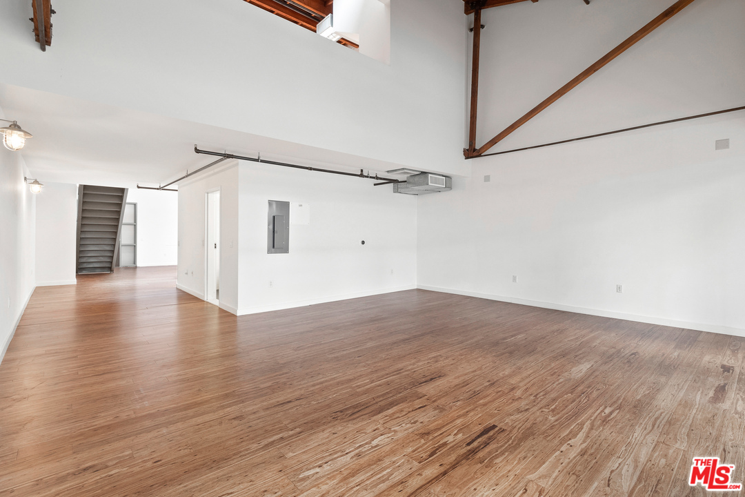 1046 Princeton Drive, Unit 210 Venice, CA 90292 - Photo 11 of 37 a view of a big room with wooden floor and windows