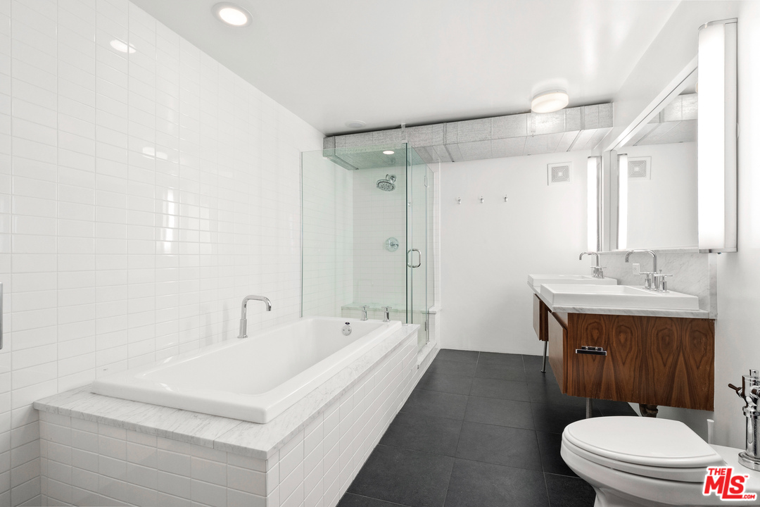 1046 Princeton Drive, Unit 210 Venice, CA 90292 - Photo 12 of 37 a bathroom with a sink a toilet a mirror and vanity
